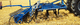 angebauter Grubber / mit Hydraulikregelung / mit Dreipunktanbau / mit Egge