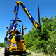 tractor-mounted reach mower / sickle bar / PTO-driven