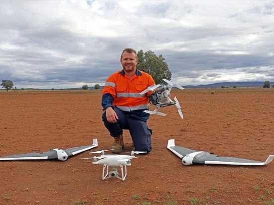 Lachlan Feeney with fixed wing and multi-rotor drones.